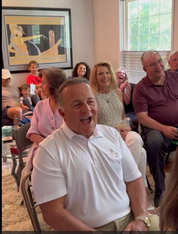 A guest laughing out loud during a Rick Silver show in a living room
