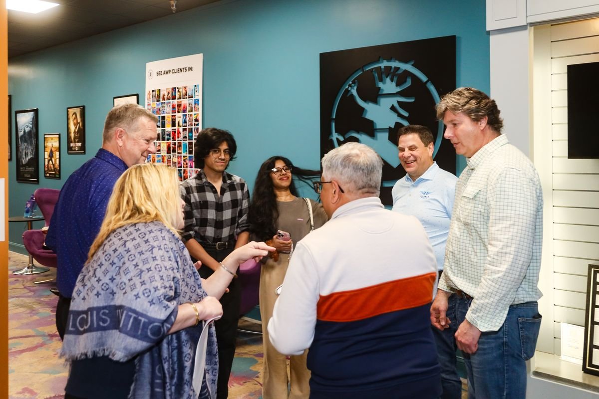 Guests gathered around Rick Silver in the lobby at Studio 13