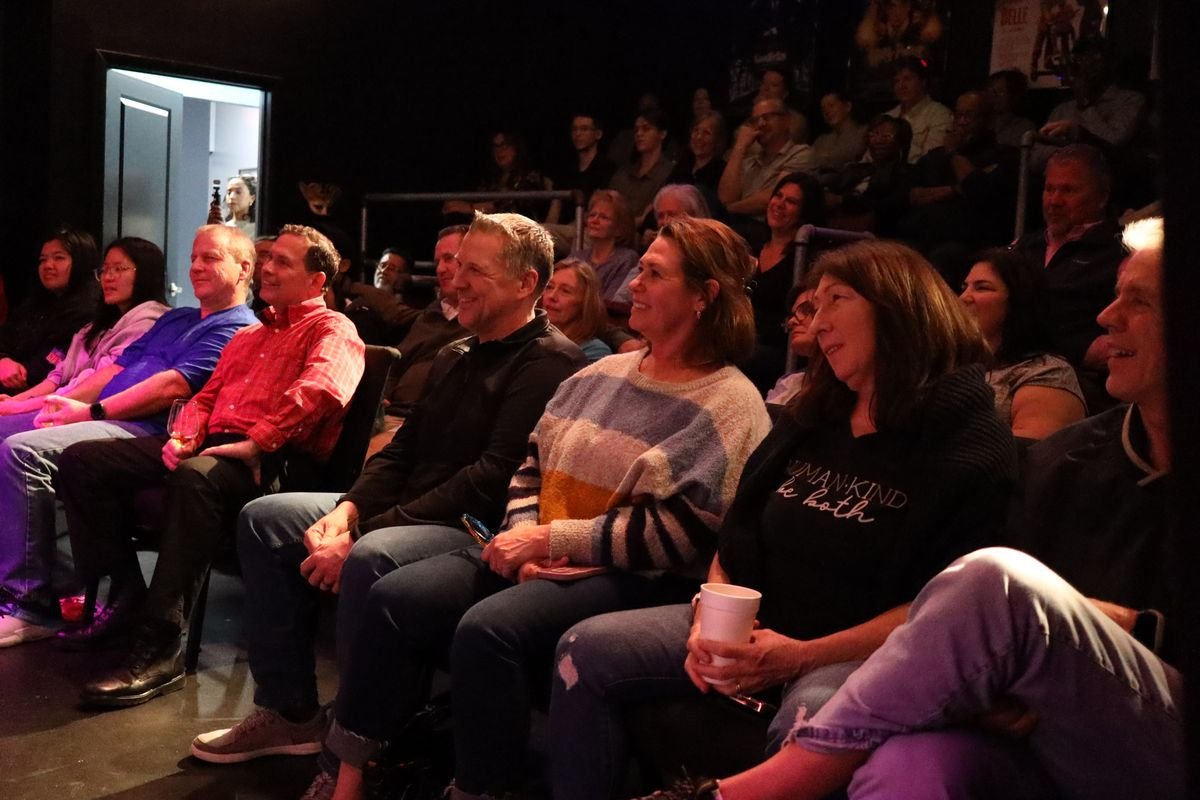 Rows of smiling guests watching Rick Silver perform at Studio 13
